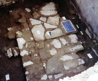 A flagstone floor and walls beneath the tile floor.